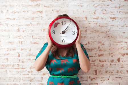 Woman holding clock